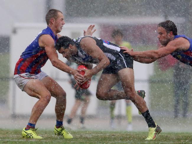 Harvey Hooper (right) claims Magpie Daniel Wells.