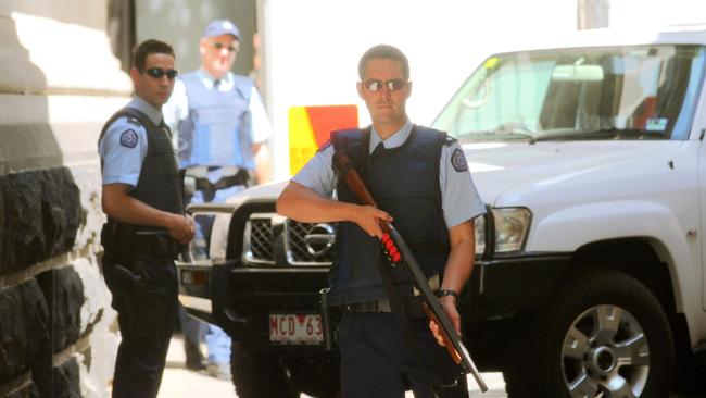 Police standing guard as Benbrika and followers are taken from the Supreme Court in 2009, after being found guilty of forming a terror cell that plotted bomb attacks designed to kill thousands in Melbourne. Picture: Supplied