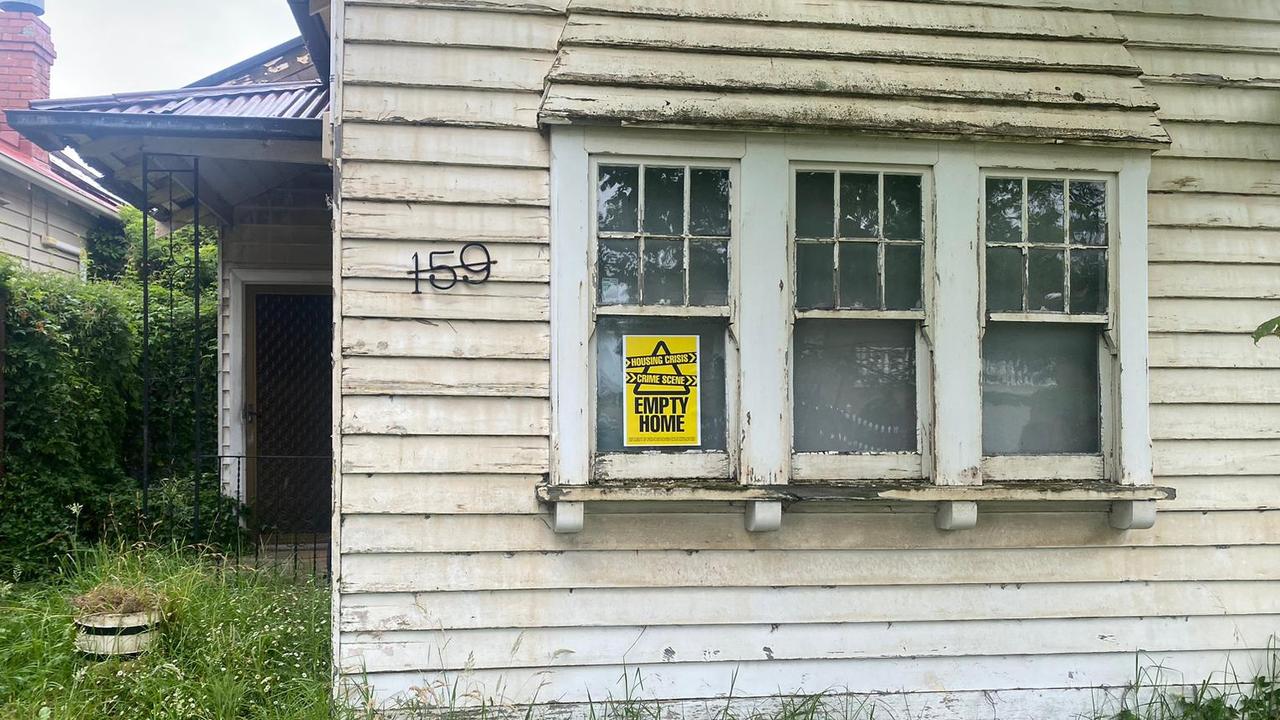 An “Empty homes crime scene” sticker on a dilapidate home’s window.