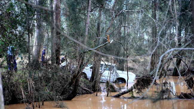 Police driver pull a ute from a swollen river after the driver Ahmed Elomar died when his car was washed away in floodwaters. Pic Stephen Cooper