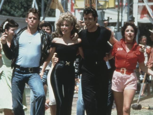 Jeff Conaway, Olivia Newton-John, John Travolta and Stockard Channing walk arm in arm on Grease. Picture: Paramount Pictures