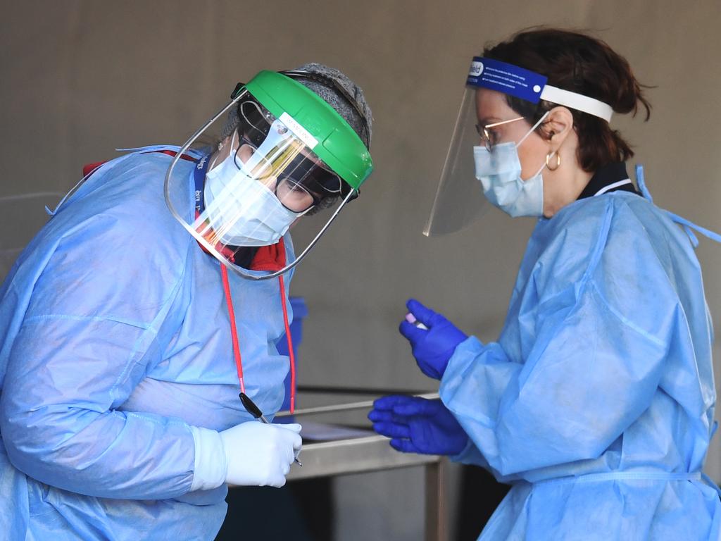 Health staff perform Covid-19 tests at a drive-through station in Brisbane. Picture: NCA NewsWire/Dan Peled