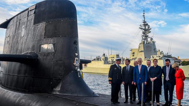 French President Emmanuel Macron (2nd L) and Malcolm Turnbull (C) stand on the deck of HMAS Waller, a Collins-class submarine operated by the Royal Australian Navy, at Garden Island in Sydney in 2018.