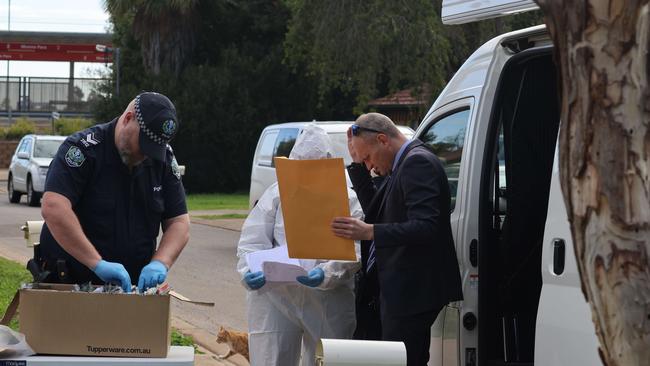 Police and detectives collect evidence at the home on Wednesday. Picture: Russell Millard