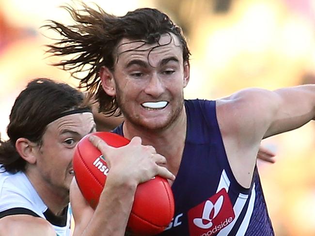PERTH, AUSTRALIA - JUNE 18: Connor Blakely of the Dockers looks to break from a tackle by Jasper Pittard of the Power during the round 13 AFL match between the Fremantle Dockers and the Port Adelaide Power at Domain Stadium on June 18, 2016 in Perth, Australia. (Photo by Paul Kane/Getty Images)