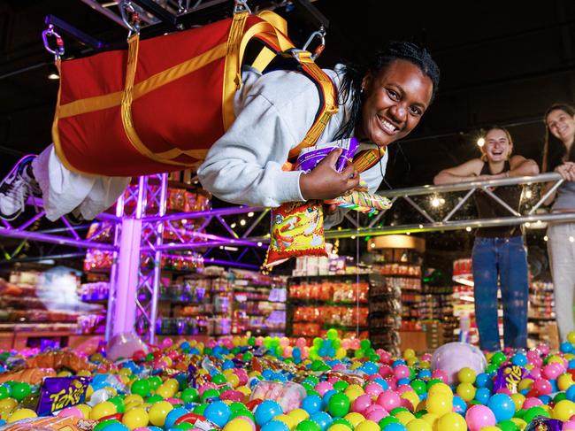 8/11/2023 (L-R) Natsai Kanhutu, Sienna Fortuna and Pia Chapman exploring AustraliaÃs largest lolly shop which is opening in Highpoint Shopping Centre, with the largest pick and mix lolly aisle, which is set to break a Guinness World record and a life size lolly claw. Aaron Francis / Herald Sun