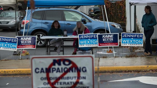 Campaign workers across the street from a polling station in Middleburg, Virginia. Picture: AFP/.