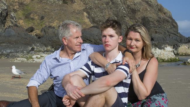 THEAUSTRALIAN- Photo in reference to The Lighthouse podcast. Photo shows Connor Meldrum (middle) with Father David Meldrum and Mother Kim Goodrick at Cosy Corner Tallows Beach Byron Bay.  Connor fell from the cliff face at Cape Byron during a climbing accident earlier this year shattering his skull which left him with severe brain injuries. 28th Nov 2019 Photo by  Natalie Grono