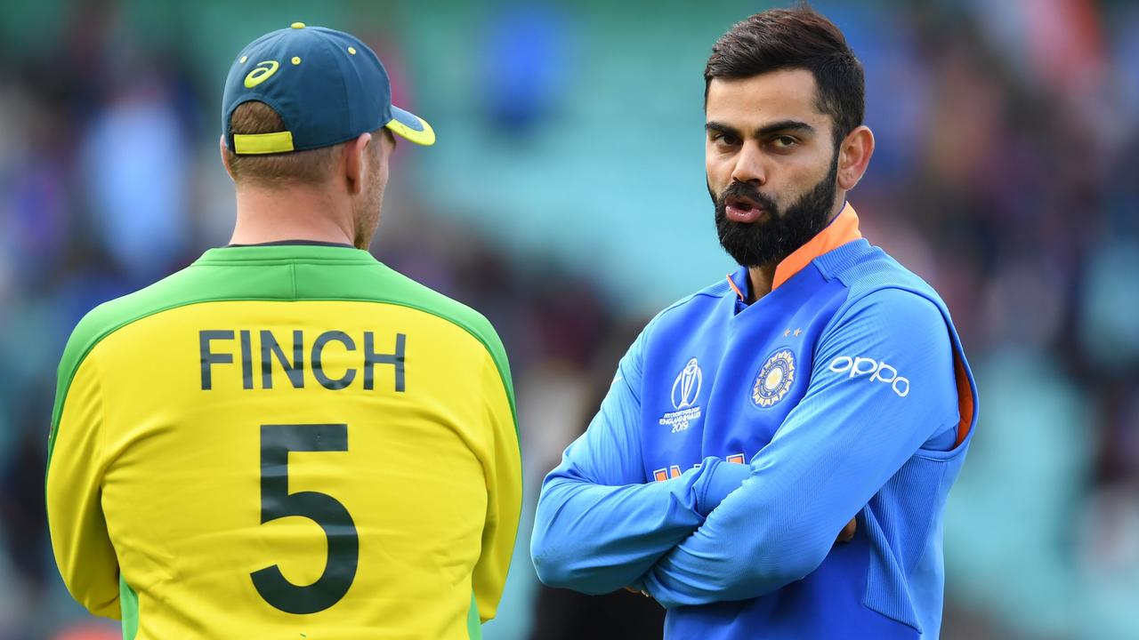 India's captain Virat Kohli (R) speaks to Australia's captain Aaron Finch