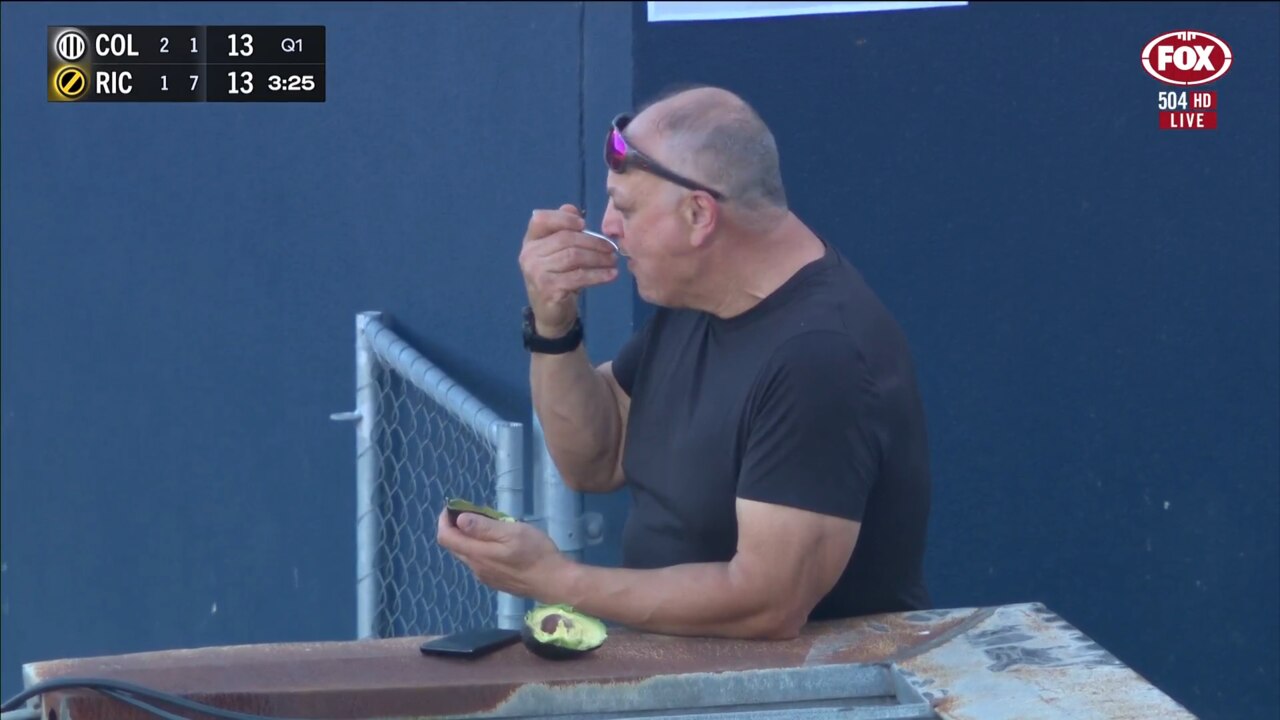 A man enjoying an unusual delicacy at the footy. Photo: Fox Footy