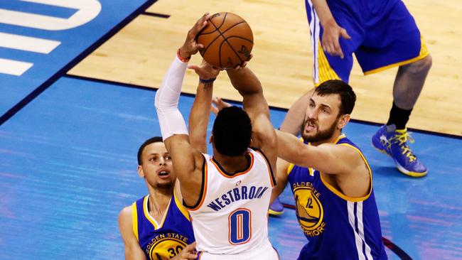 Andrew Bogut #12 of the Golden State Warriors (R) attempts to defend against Russell Westbrook #0 of the Oklahoma City Thunder.