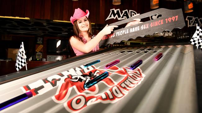 Mad Cow bartender Kristian Bowkett gets a dildo race started. Picture: Alix Sweeney