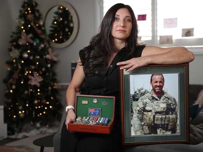 Gwen Cherne with the medals and meritorious citation of her partner Peter Cafe (pictured) who served in Afghanistan. Picture: Richard Dobson.