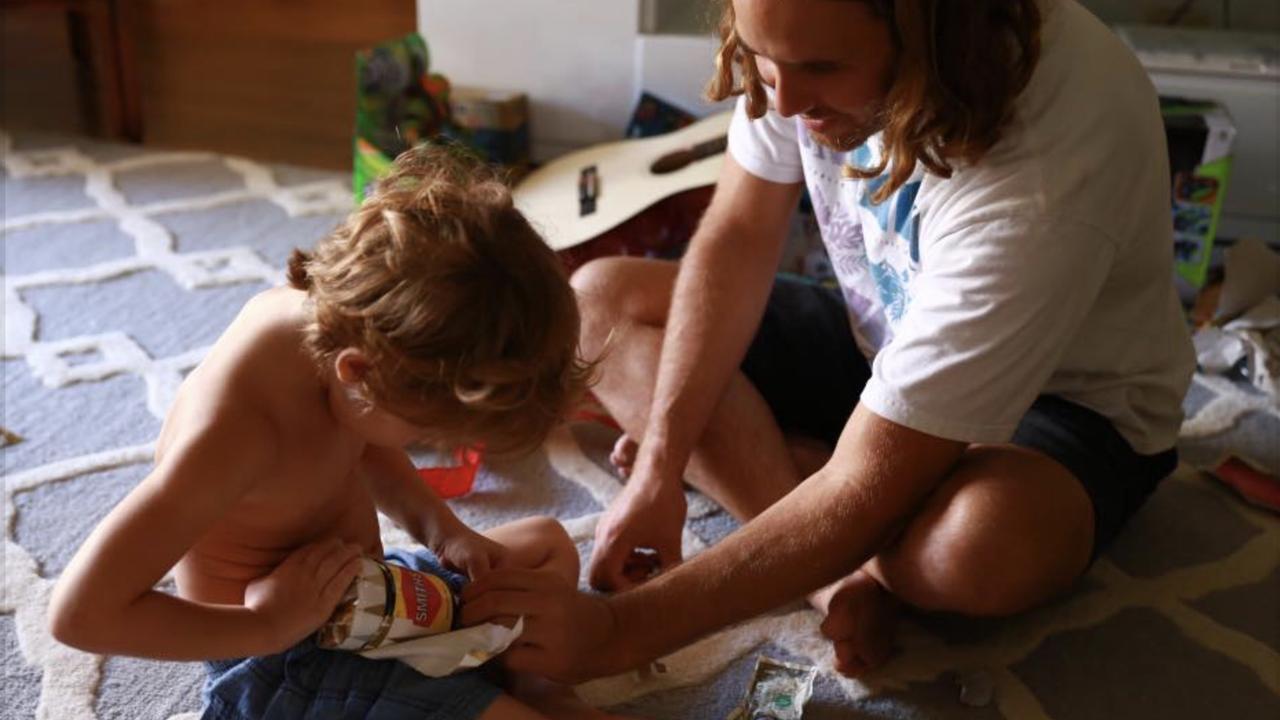 Matt and Jacksen opening a jar of Vegemite at Christmas. Picture: Supplied.