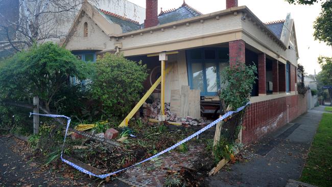 A house on the corner of Dryburgh and Canning Streets North Melbourne damaged after a car crashed through its front fence. Picture: Andrew Henshaw