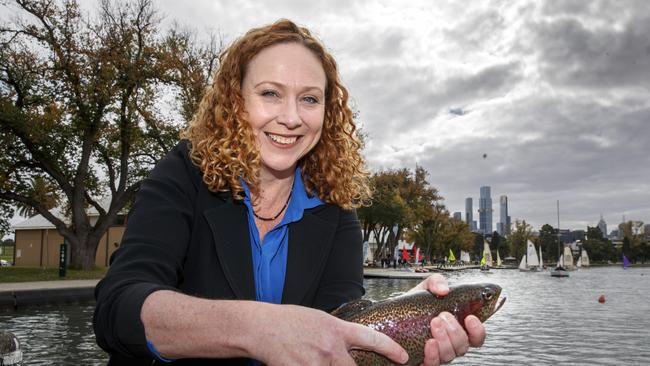 Former Fishing Minister Melissa Horne releasing trout into Albert Park Lake, one of 50 parks where government agencies would be able to ban recreational fishing under proposed regulations.