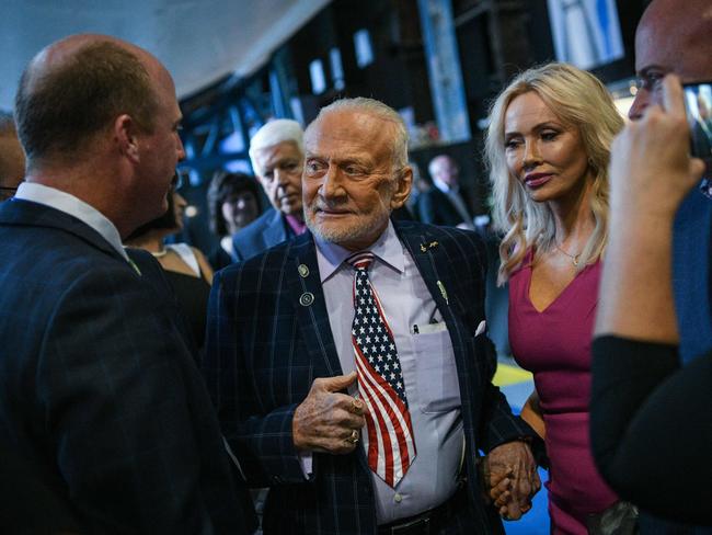 Former NASA astronaut Buzz Aldrin makes his entrance with girlfriend Anca Faur at an Apollo 11 anniversary celebration dinner. Picture: AFP