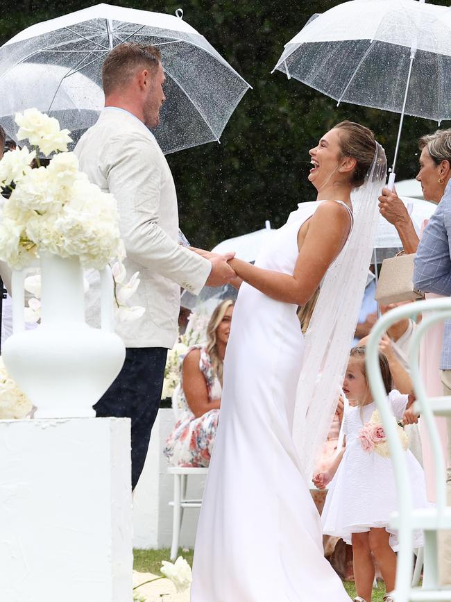 … with the couple exchanging vows as the skies opened.