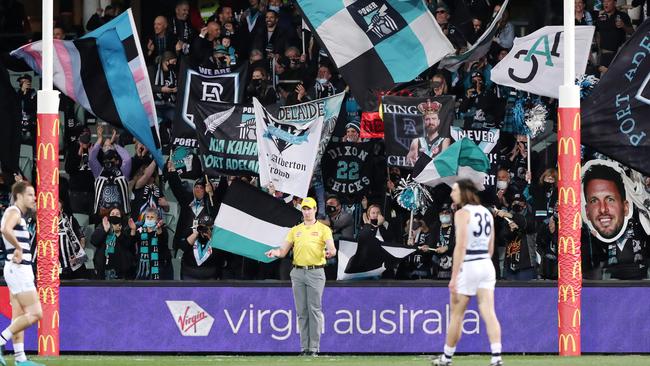 Port Adelaide fans celebrate a goal during the 2021 AFL Second Qualifying Final match between the Port Adelaide Power and the Geelong Cats at Adelaide Oval. Picture: Sarah Reed