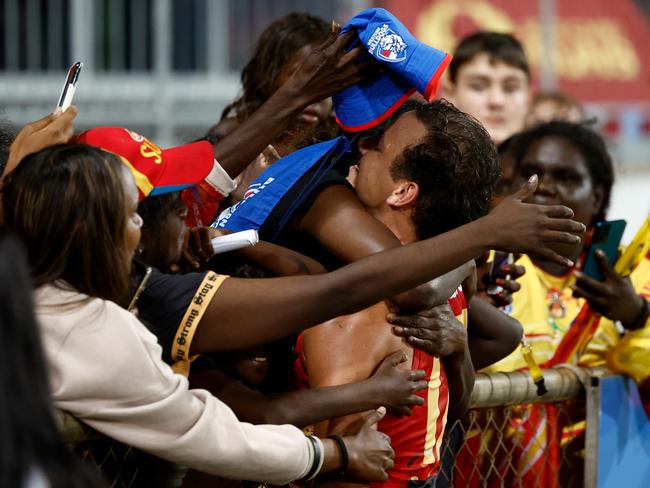 Daniel Rioli is embraced by family after Gold Coast’s win in Darwin.