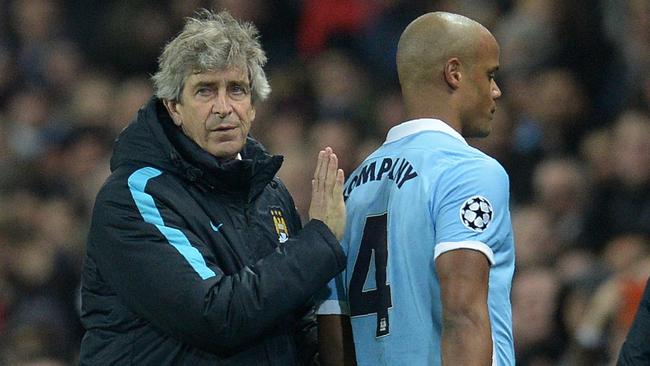 Manchester City's Chilean manager Manuel Pellegrini (L) consoles Manchester City's Belgian defender Vincent Kompany as he leaves the pitch injured during a UEFA Champions League last 16, second leg football match between Manchester City and Dynamo Kiev at the Etihad Stadium in Manchester, north west England, on March 15, 2016. / AFP PHOTO / OLI SCARFF