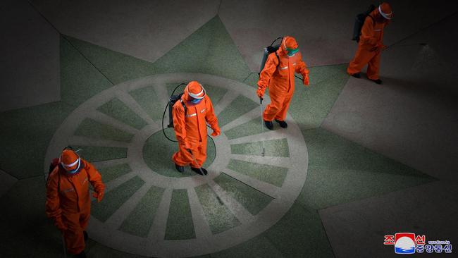 Railway staff disinfect Pyongyang station on Tuesday. Picture: KCNA via AFP