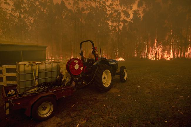 Fire approaches a property at Bawley Point, on the NSW south coast. Picture: Gary Ramage