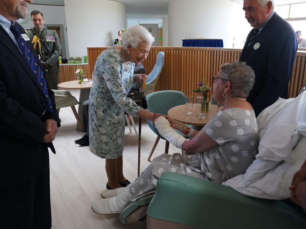 The Queen jokes with Pat White, who’s husband’s phone rang during the Royal audience. Picture: Getty Images