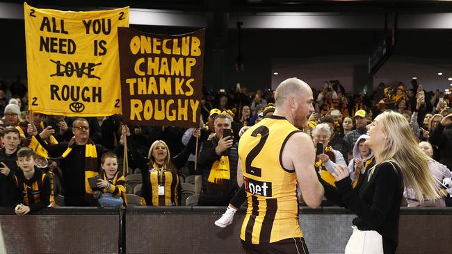 Jarryd Roughead of the Hawks greets his wife Sarah Dunn and daughter Pippa