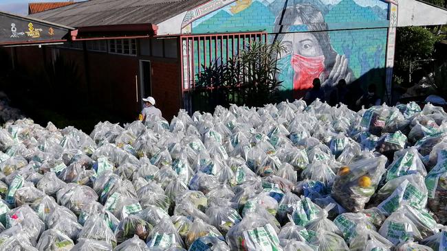 Bags with food are gathered before they’re delivered to vulnerable Colombian families. Picture: AFP