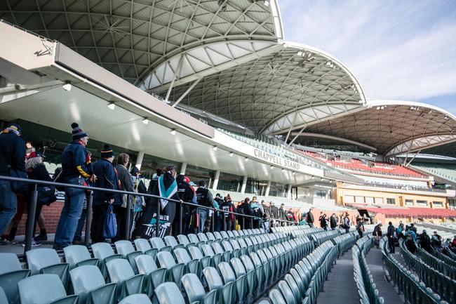 Crows and Port Adelaide fans walking into Adelaide Oval to be extras in film 