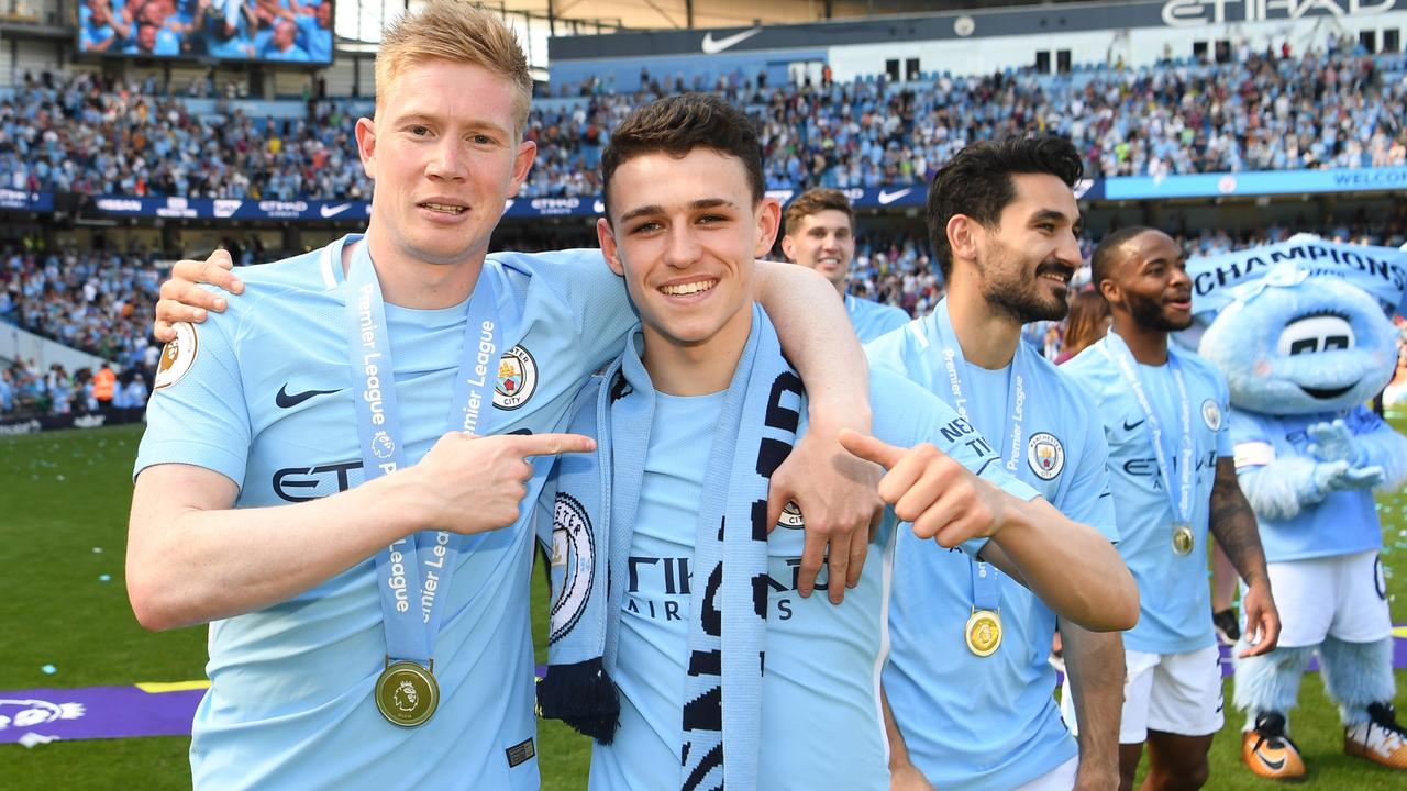 Kevin De Bruyne and Phil Foden of Manchester City celebrate winning the Premier League.