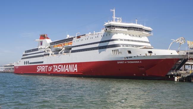 Melbourne, Australia - March 14, 2017: A woman on a stand up paddle board approaches the Spirit of Tasmania, an interstate passenger ferry docked at Station Pier in Port Melbourne.