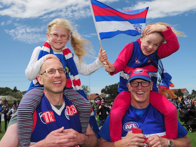 Three generations of Bulldogs, sisters Willow and Elana with dad Adam and grandad Tony. Picture: Eugene Hyland
