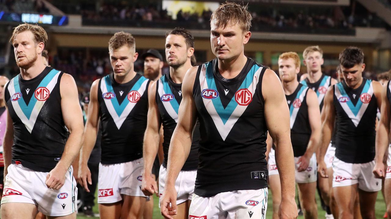 Tom Jonas and Ollie Wines lead the Power off the ground that night. Picture: Sarah Reed/AFL Photos via Getty Images