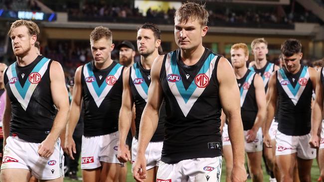 Tom Jonas and Ollie Wines lead the Power off the ground that night. Picture: Sarah Reed/AFL Photos via Getty Images