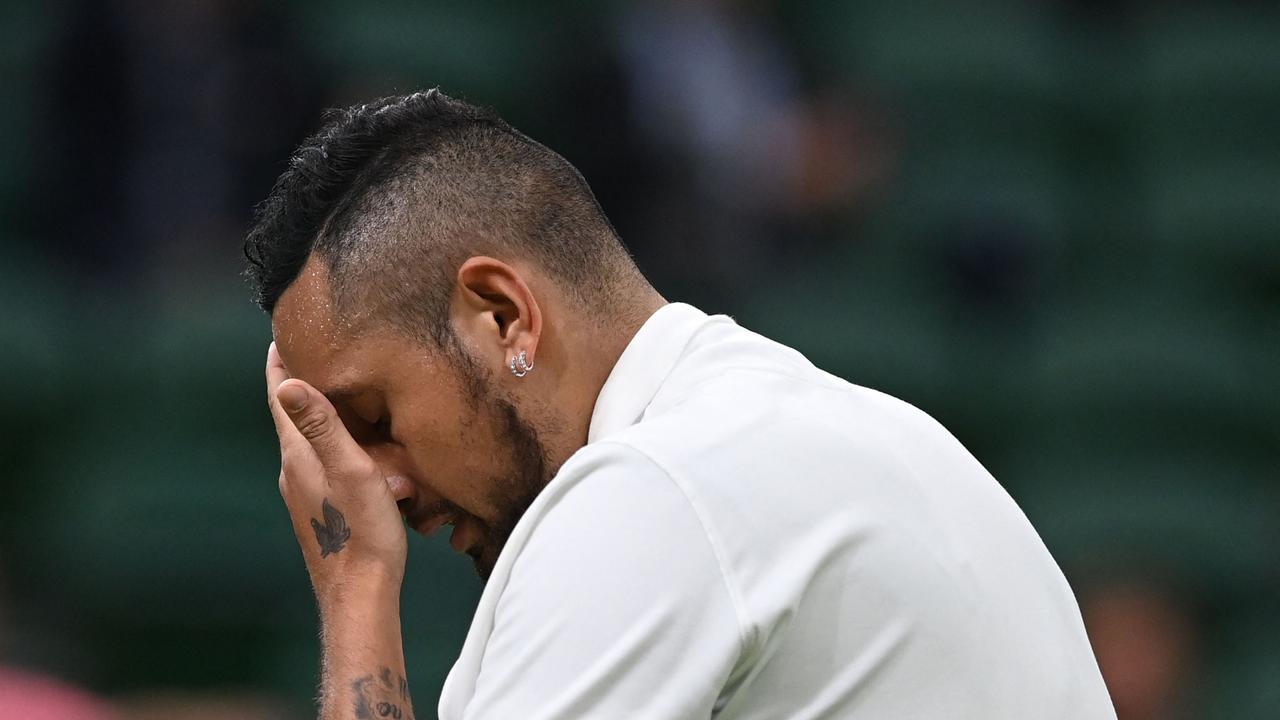 Australia's Nick Kyrgios wipes his face during play against France's Ugo Humbert at their men's singles first round match on the second day of the 2021 Wimbledon Championships at The All England Tennis Club in Wimbledon, southwest London, on June 29, 2021. (Photo by Glyn KIRK / AFP) / RESTRICTED TO EDITORIAL USE