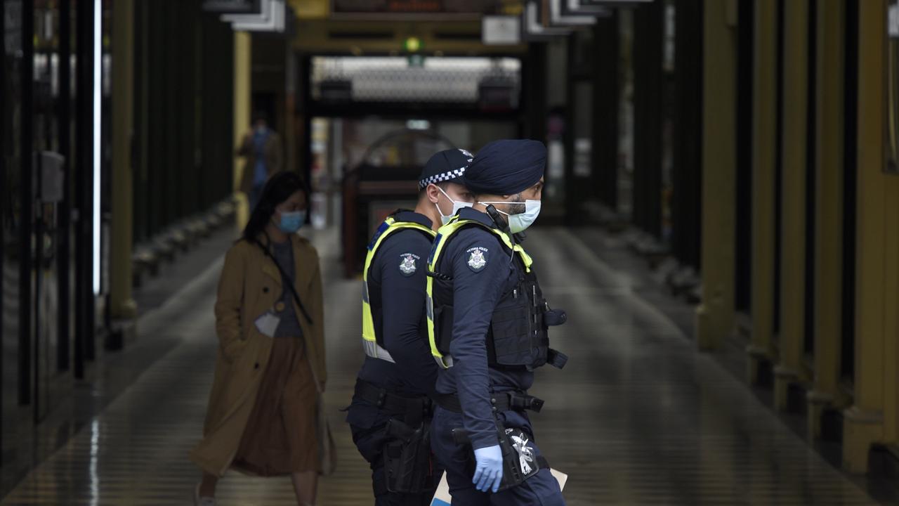 Police patrol Royal Arcade in central Melbourne as the city goes through its second week of lockdown. Picture: NCA NewsWire / Andrew Henshaw