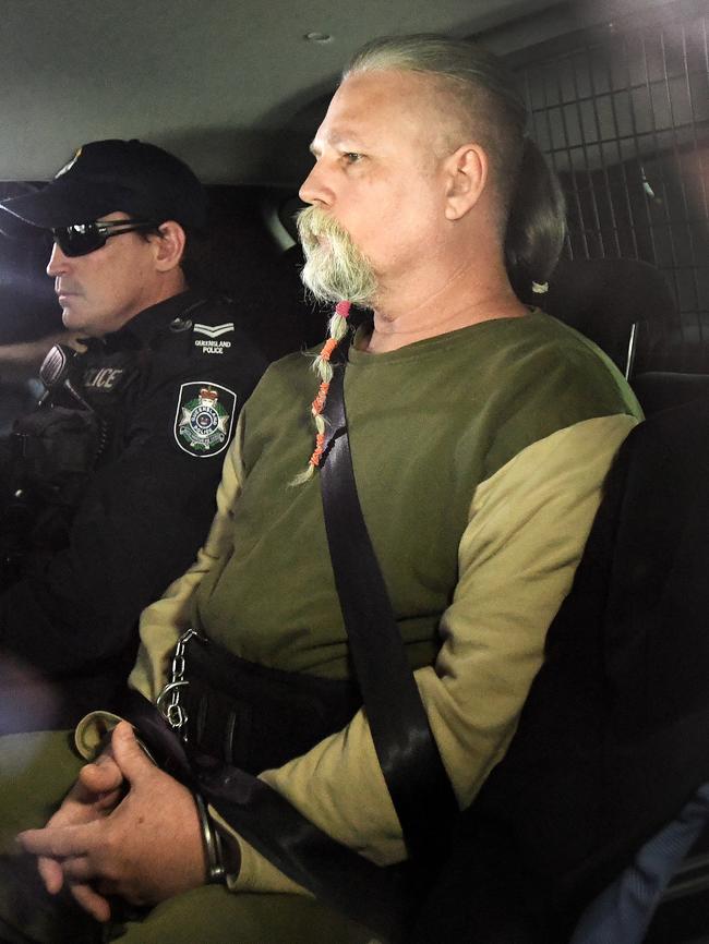 Troy James O’Meara being driven by police to the Police Watch House in Brisbane (AAP Image/Dave Hunt)