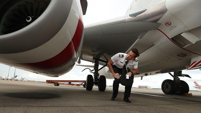 Virgin Australia first officer Ian Morrison performs a pre-flight inspection on an aircraft at Brisbane airport. Picture: Lyndon Mechielsen