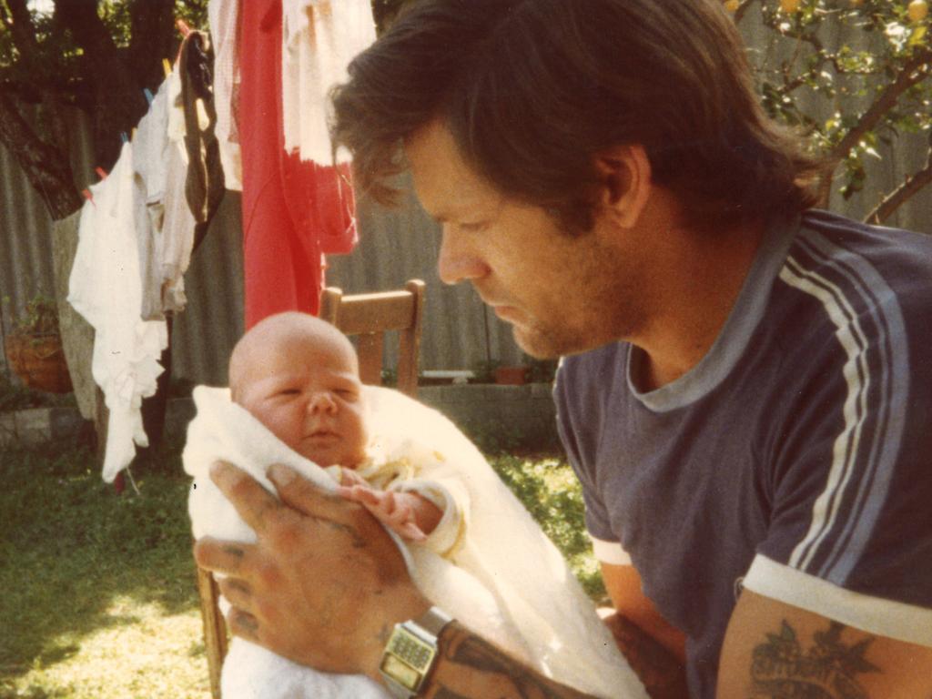 Allan holds his daughter Nina, pictured in Fremantle in 1984.