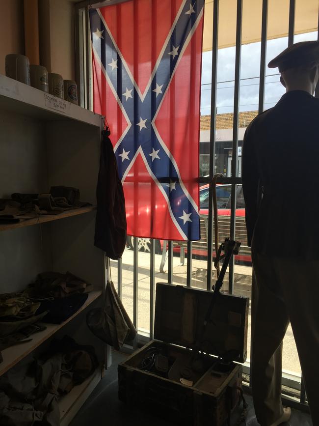 A Confederate flag hangs in the front window.