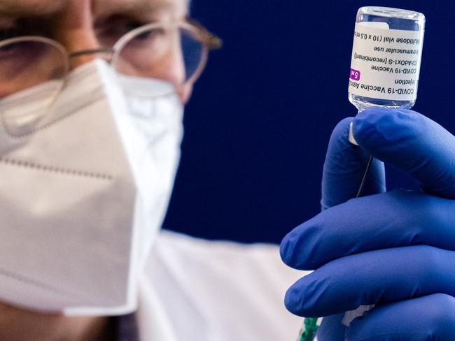 FILES) In this file photo taken on February 12, 2021 a healthcare worker fills a syringe with the AstraZeneca Covid-19 vaccine at the university hospital in Halle/Saale, eastern Germany. - Germany on on March 15, 2021 halted the use of AstraZeneca's coronavirus vaccine after reported blood clotting incidents in Europe,  saying that a closer look was necessary. (Photo by JENS SCHLUETER / AFP)