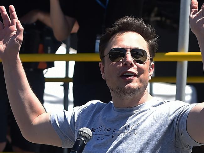 (FILES) In this file photo taken on July 22, 2018 SpaceX, Tesla and The Boring Company founder Elon Musk speaks at the 2018 SpaceX Hyperloop Pod Competition, in Hawthorne, California. Tesla chief executive Elon Musk said August 7, 2018 he would remain CEO of the electric automaker even if it ceases to be publicly traded. Trading in the company's shares were suspended mid-afternoon following Musk's suggestion that it could go private. Before that, they had surged by more than seven percent."No change," Musk replied to a Twitter user who asked whether he would like to stay on in his current position.  / AFP PHOTO / Robyn Beck