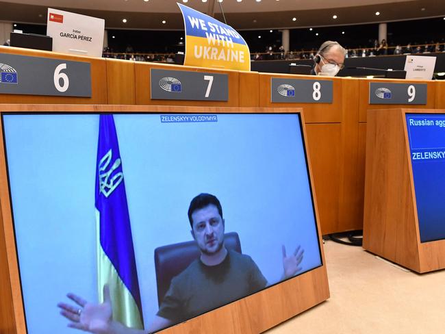 Ukrainian President Volodymyr Zelensky appears on a screen as he speaks in a video conference during a special plenary session of the European Parliament. Picture: AFP