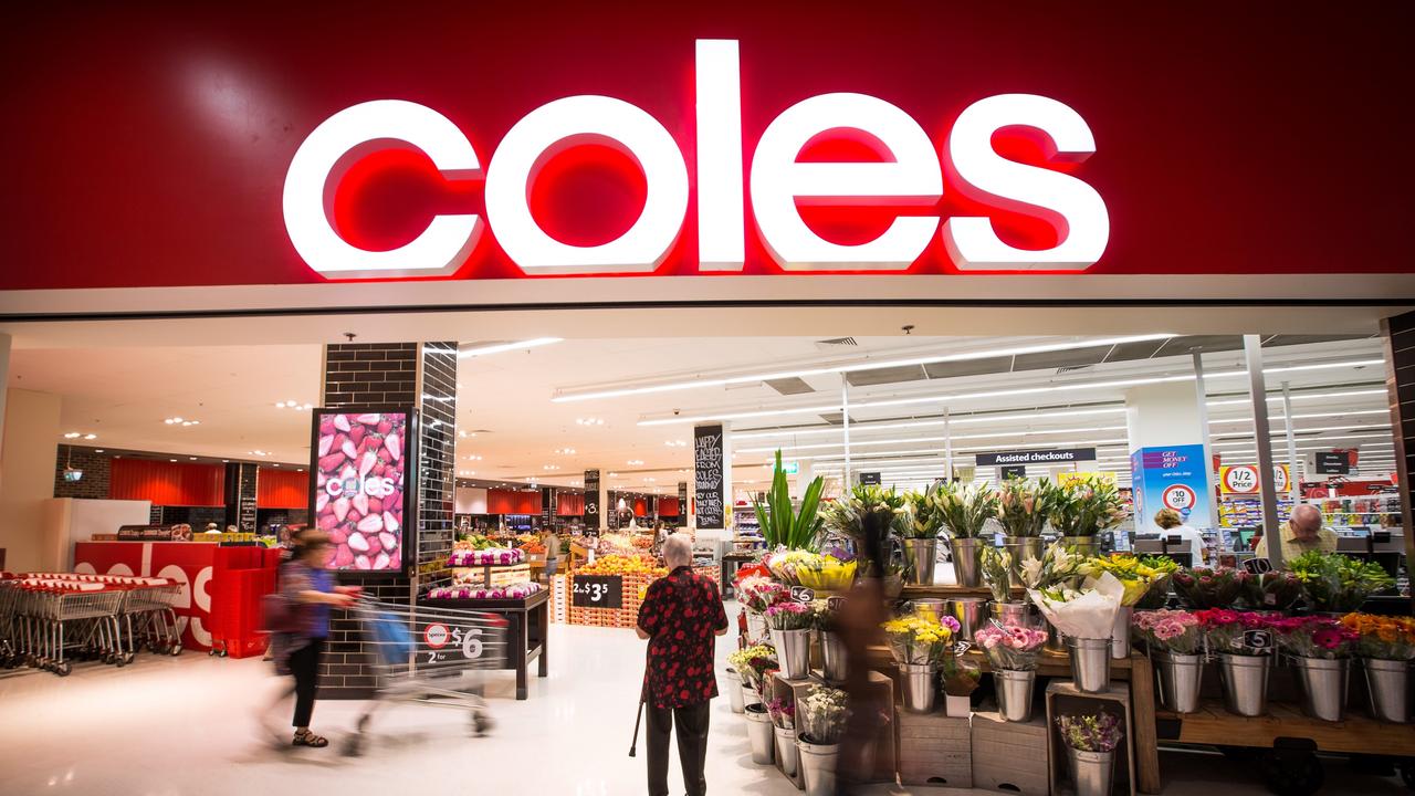 A shopper stands at the entrance to a Coles supermarket. Picture: Ian Waldie/Bloomberg via Getty Images