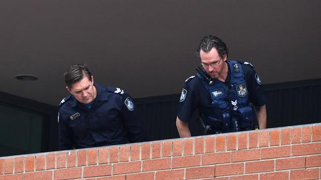 Police look over the crime scene at Somerville House. Picture: AAP/Darren England