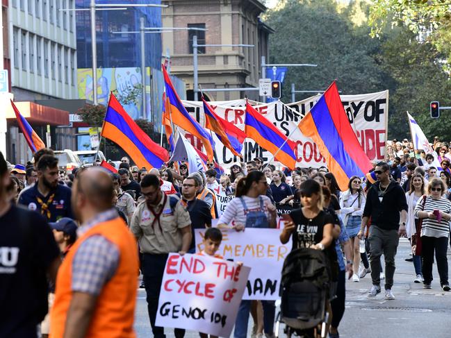 Protesters march with Armenian flags during a rally in Sydney, Sunday, April 28th, 2019. Hundreds of Armenian Australians have marched in Sydney to pressure the Federal government to recognise the Ottoman Empire's extermination of about 1.5 million Armenians over the course of a decade from April 1915 as genocide. (AAP Image/Bianca De Marchi) NO ARCHIVING