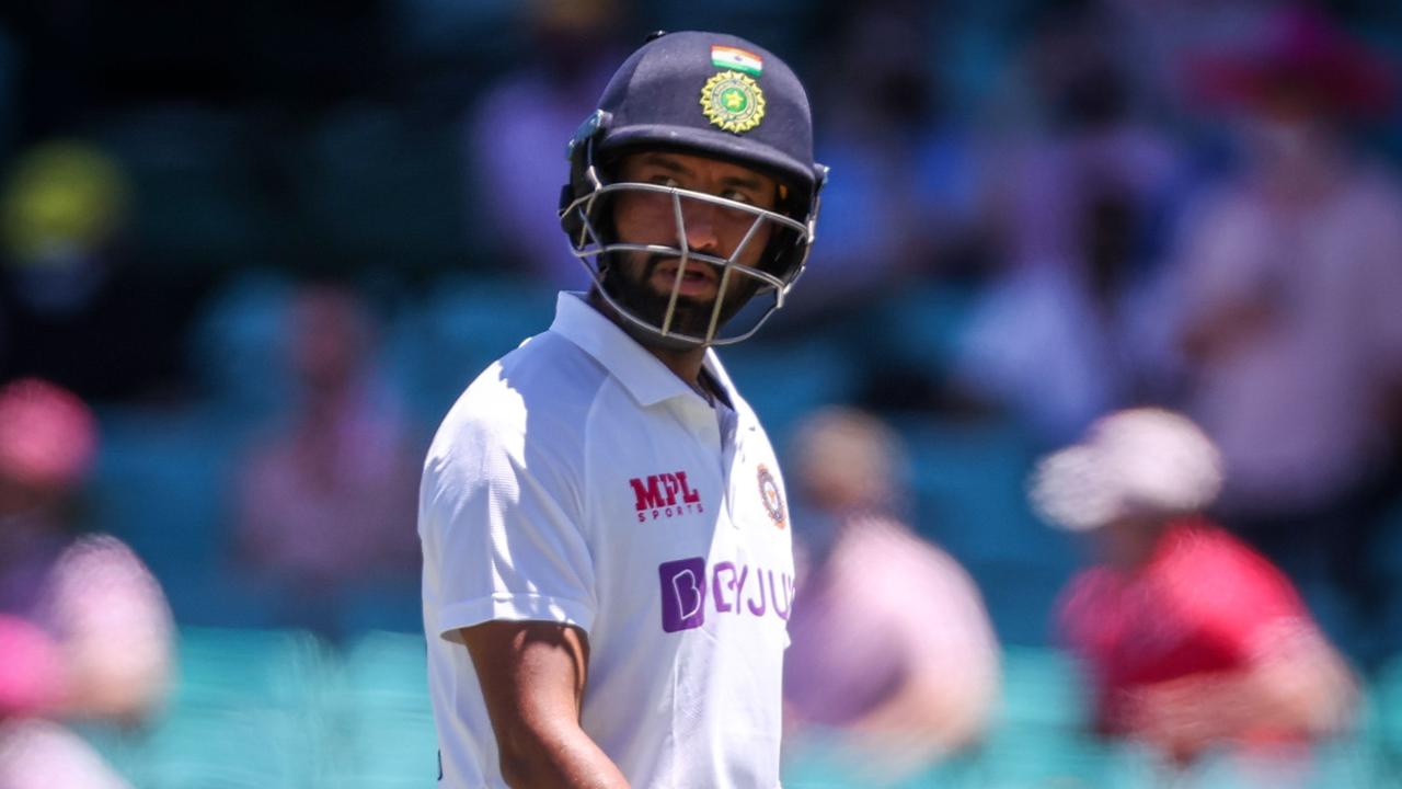 India's Cheteshwar Pujara walks off the ground after being dismissed by Australia's Pat Cummins.