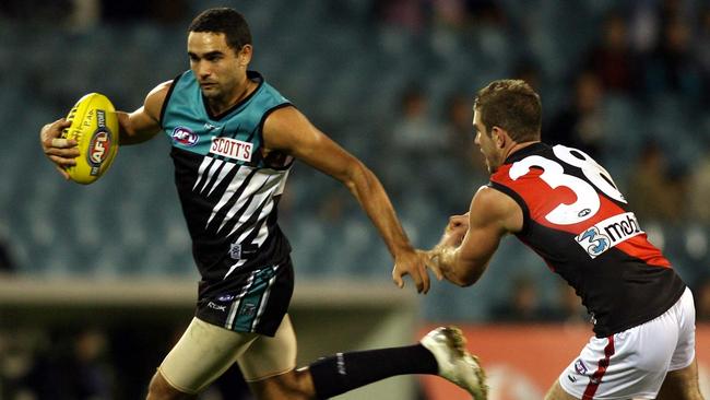 Jay Nash chases Shaun Burgoyne during his time as a Bomber. Both players were involved in the deal which saw Burgoyne end up at the Hawks.